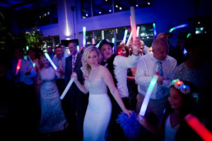 bride and guests on the dancefloor playing with flowing sticks