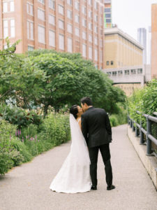 Newlyweds kissing with their back to camera