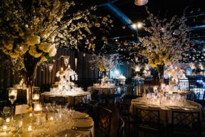 Dinner tables with extravagant floral arrangements