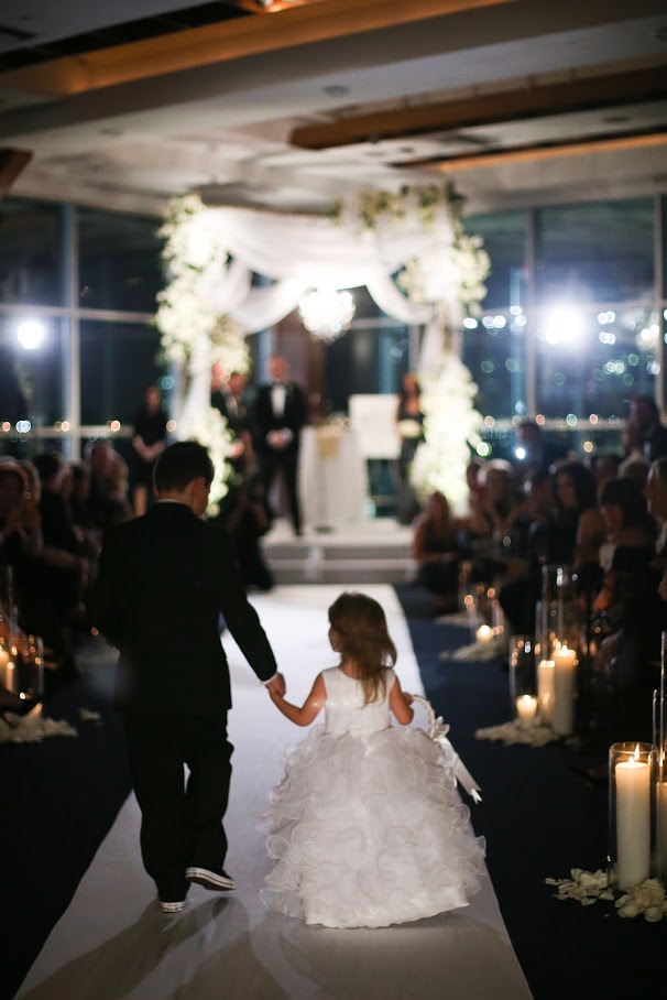 a boy and a girl walking down the aisle