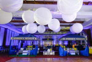 Giant white balloons hang above dance floor at tailgate themed Mitzvah