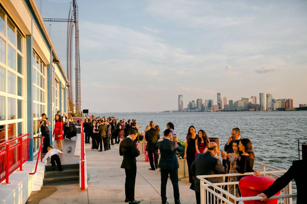 guests standing in the veranda by the hudson river
