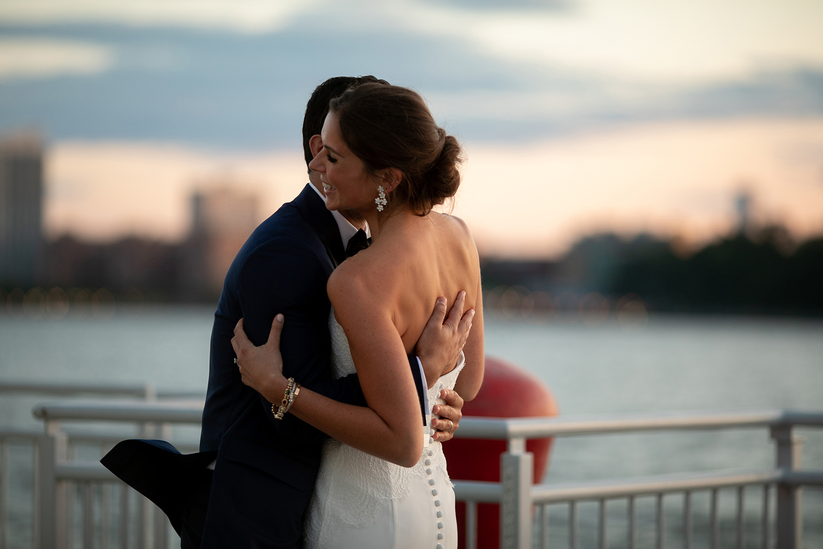 Bride and Groom hugging in front of the Hudson River