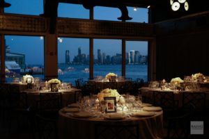dinner tables with stunning view in the background of the Hudson River and New Jersey Skyline at dusk