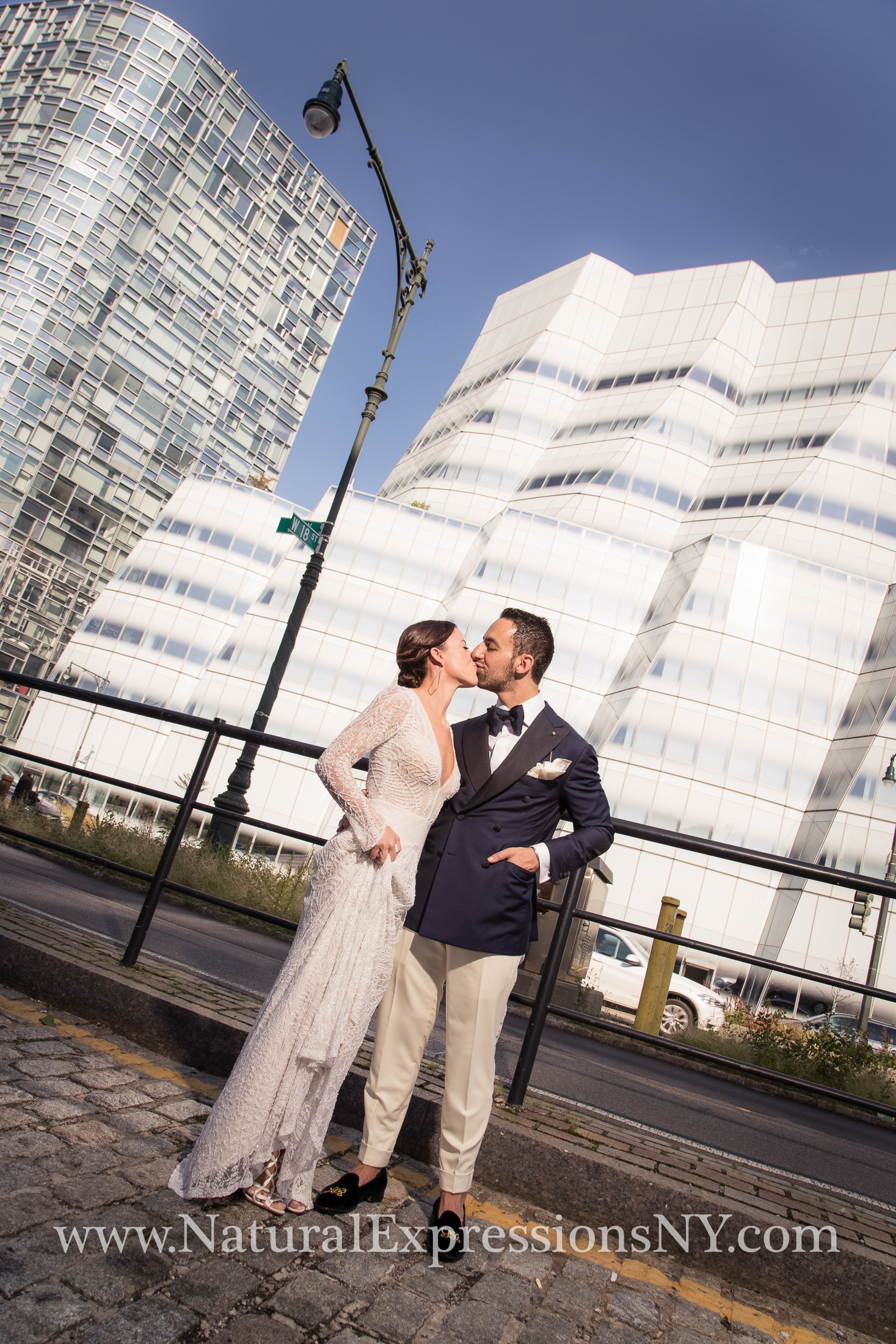 Bride and groom kissing at Pier 59 with modern building (IAC) in the background