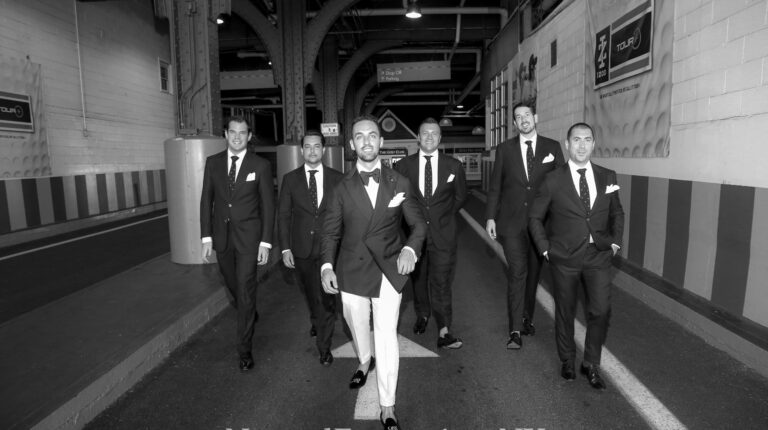 Groom and groomsmen posing at the entrance of Pier 59, black and white picture