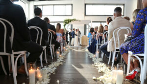 View down the wedding aisle with flowers and candles.