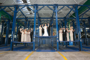 bride, groom and bridal party having fun in the parking lot of Current at Pier 59