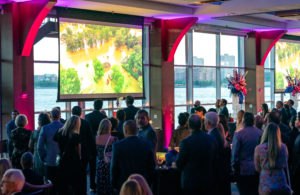 Cocktail Reception at Pier Sixty, guests looking at the screens